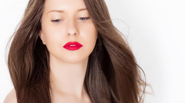 Beautiful woman with healthy gorgeous long hair, natural brunette hairstyle and red lipstick makeup, haircare and beauty ad.