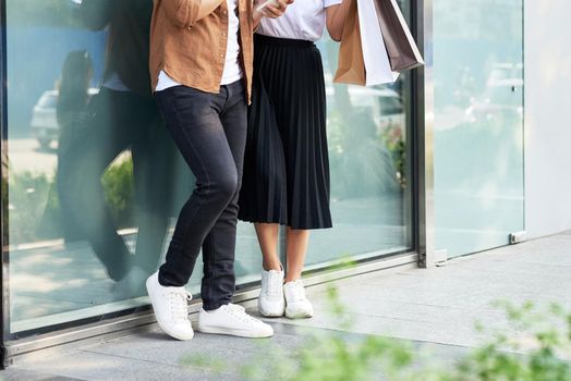 A picture of a couple shopping with smartphone in the city 