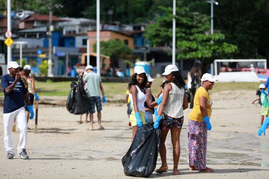 salvador, bahia, brazil - june 5, 2015: social action with volunteers cleaning the beach of Sao Tome de Paripe in the city of Salvador.