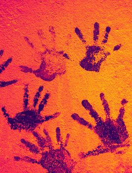 Color background of children's handprints. Multi colored hand prints.