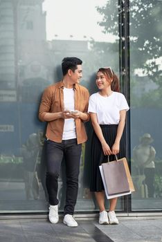 A picture of a couple shopping with smartphone in the city 