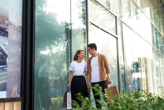 Young happy couple with shopping bags in the city.