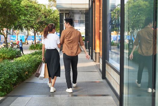 Young happy couple with shopping bags in the city,having fun together