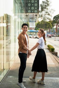 Young happy couple with shopping bags in the city,having fun together