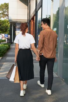 Young happy couple with shopping bags in the city,having fun together