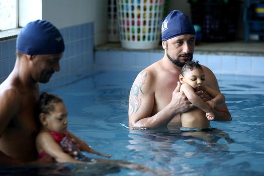 lauro de freitas, bahia, brazil - september 29, 2017: Children with microcephaly during swimming lesson at a club in the city of Lauro de Freitas. The deformity was adequate due to the zica virus.