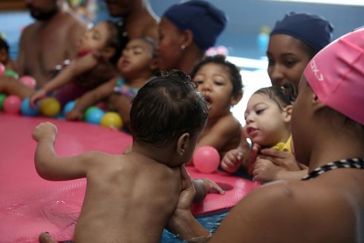 lauro de freitas, bahia, brazil - september 29, 2017: Children with microcephaly during swimming lesson at a club in the city of Lauro de Freitas. The deformity was adequate due to the zica virus.
