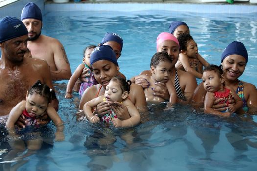 lauro de freitas, bahia, brazil - september 29, 2017: Children with microcephaly during swimming lesson at a club in the city of Lauro de Freitas. The deformity was adequate due to the zica virus.