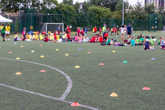 Children competing during school sports day in the UK. Blurred image with selective focus.