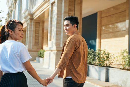 Couple with shopping bags holding hands at shopping mall