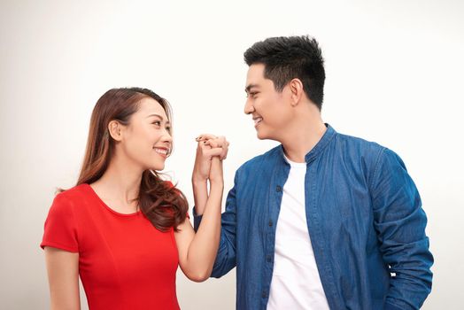 Happy Asian couple holding hand over white background