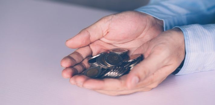 Hands of businessman holding money with coin, investment and profit, fund and growth about finance, economy and financial, planning saving, accounting for success and income, business concept.
