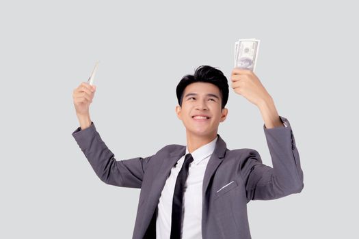 Young asian business man holding money dollar isolated on white background, businessman in suit holding banknote and success and excited with finance, savings and investment, income and spending.