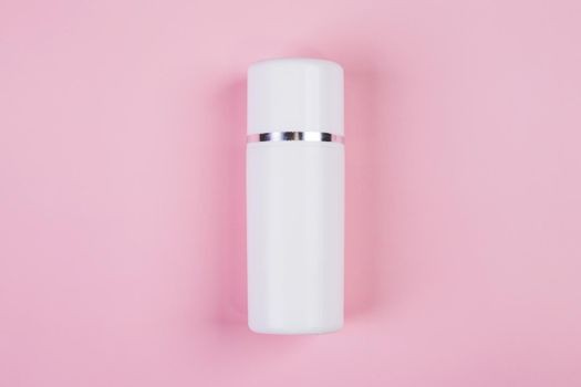 Mockup cosmetic bottle with cream or lotion isolated on pink background, mock up package for advertising, skincare or cosmetology, top view, flat lay, skin care and treatment with product.