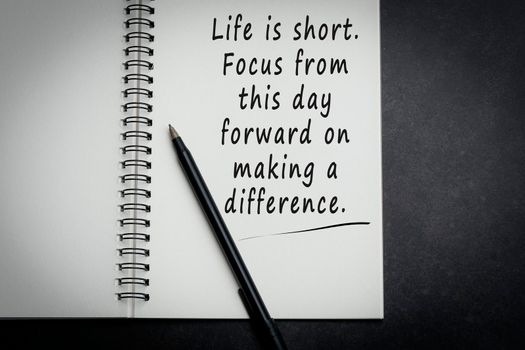 Motivational and inspirational quote on notebook with dark background