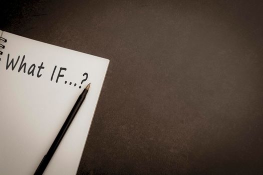 What If text on notepad with dark background
