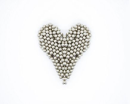 Heart shape made of metal sphere segments on white background.