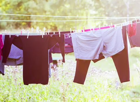 Washed colorful clothes hanging on a clothesline outdoors