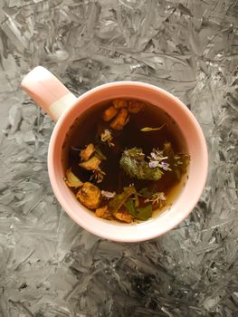 Natural herbal tea with medical herbs in ceramic cup