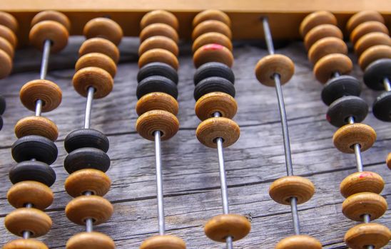 Vintage wooden abacus on old board surface.