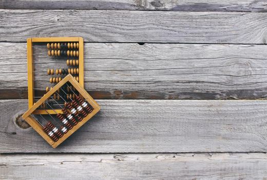 Vintage wooden abacus on old board surface.