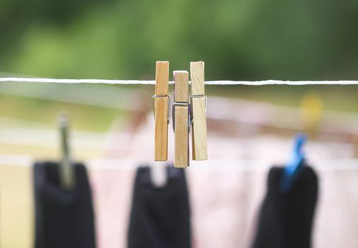 Colorful laundry hanging on the rope outdoors. The process of air drying clothes