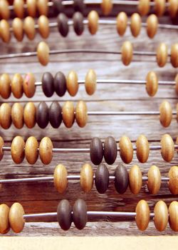 Vintage wooden abacus on old board surface.