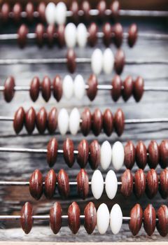 Vintage wooden abacus on old board surface.