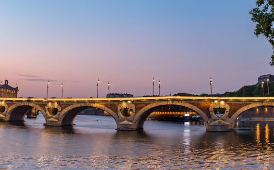 Sunset in the Garonne river and its bridges in Toulouse in Haute-Garonne, Occitania, France.