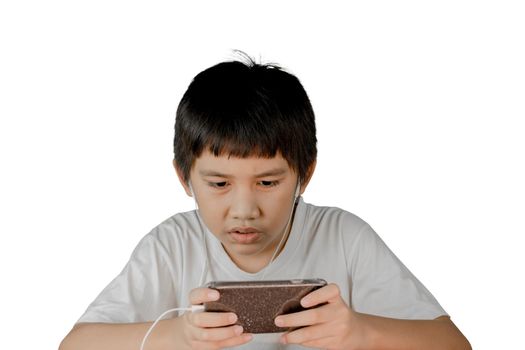 Asian boy wearing headphones and white shirt playing a games on his smart phone isolated on white background.