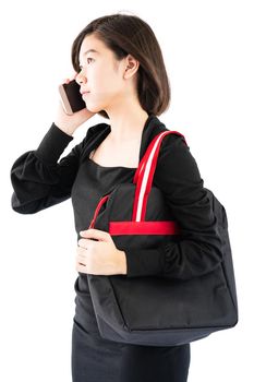 Woman carrying a black shopping bag using cellphone shopping online isolate on white background