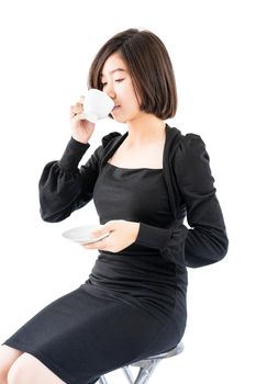 Young woman sittng holding coffee cup on white background