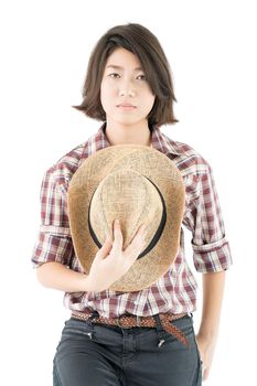 Young pretty woman in a cowboy hat and plaid shirt posing in studio with isolated on white background