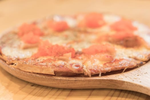 smoked salmon pizza on wood table