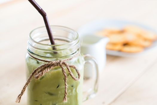 iced matcha latte on wood background