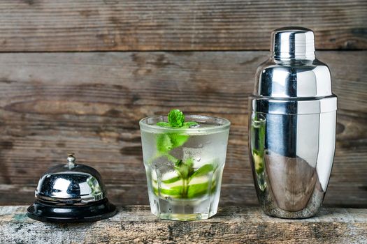 Mojito cocktail in a bur on a rustic table, selective focus

