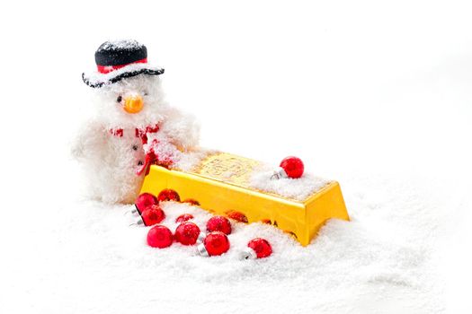 Christmas man with a goldbar and red christmas balls in the snow