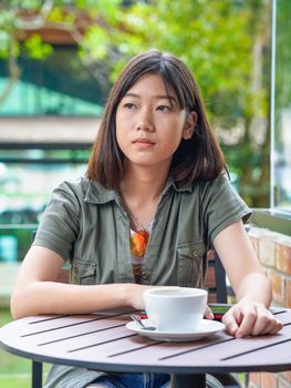 Pretty woman sitting in a cafe terrace with coffee cup