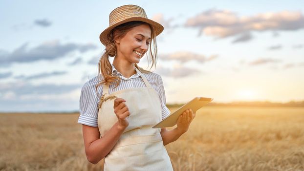 Female agronomist specialist research monitoring analysis data agribusiness Woman farmer straw hat smart farming standing farmland smiling using digital tablet Caucasian worker agricultural field