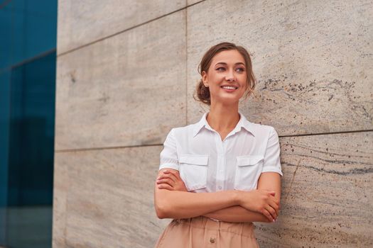 Businesswoman successful woman business person standing arms crossed outdoor corporate building exterior Smile happy caucasian confidence professional business woman middle age female entrepreneur