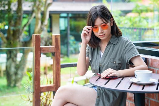 Pretty woman sitting in a cafe terrace with coffee cup