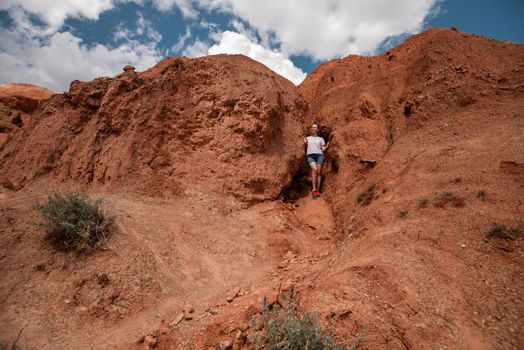 Woman in valley of Mars landscapes in the Altai Mountains, Kyzyl Chin, Siberia, Russia