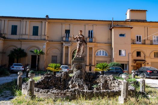 rieti.italy july 06 2021:rieti fountain with sculpture in the courtyard of a building without water