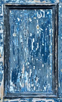 The door panel is heavily weathered and shows various layers of paint through to the wood.