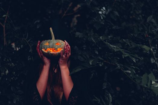 Portrait woman scary ghost in forest he has holding pumpkin dark tone, halloween concept