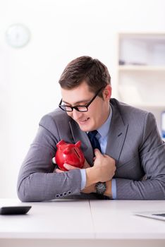 Young employee with piggybank in pension savings concept