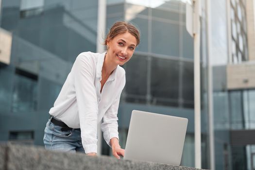 Businesswoman successful woman business person outdoor corporate building exterior with laptop Pensive elegance cute caucasian professional business woman middle age ecommerce deal Online banking