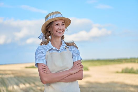Woman farmer straw hat apron standing farmland smiling showing thumb up sign Female agronomist specialist farming agribusiness Happy positive caucasian worker agricultural field