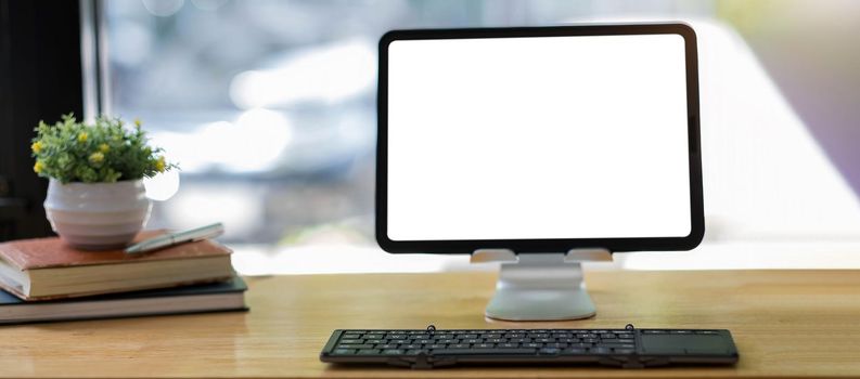 Blank screen Laptop computer and poster workspace background in modern office.