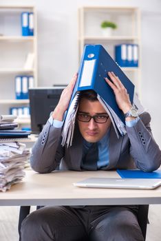 Overloaded with work employee under paperwork burden